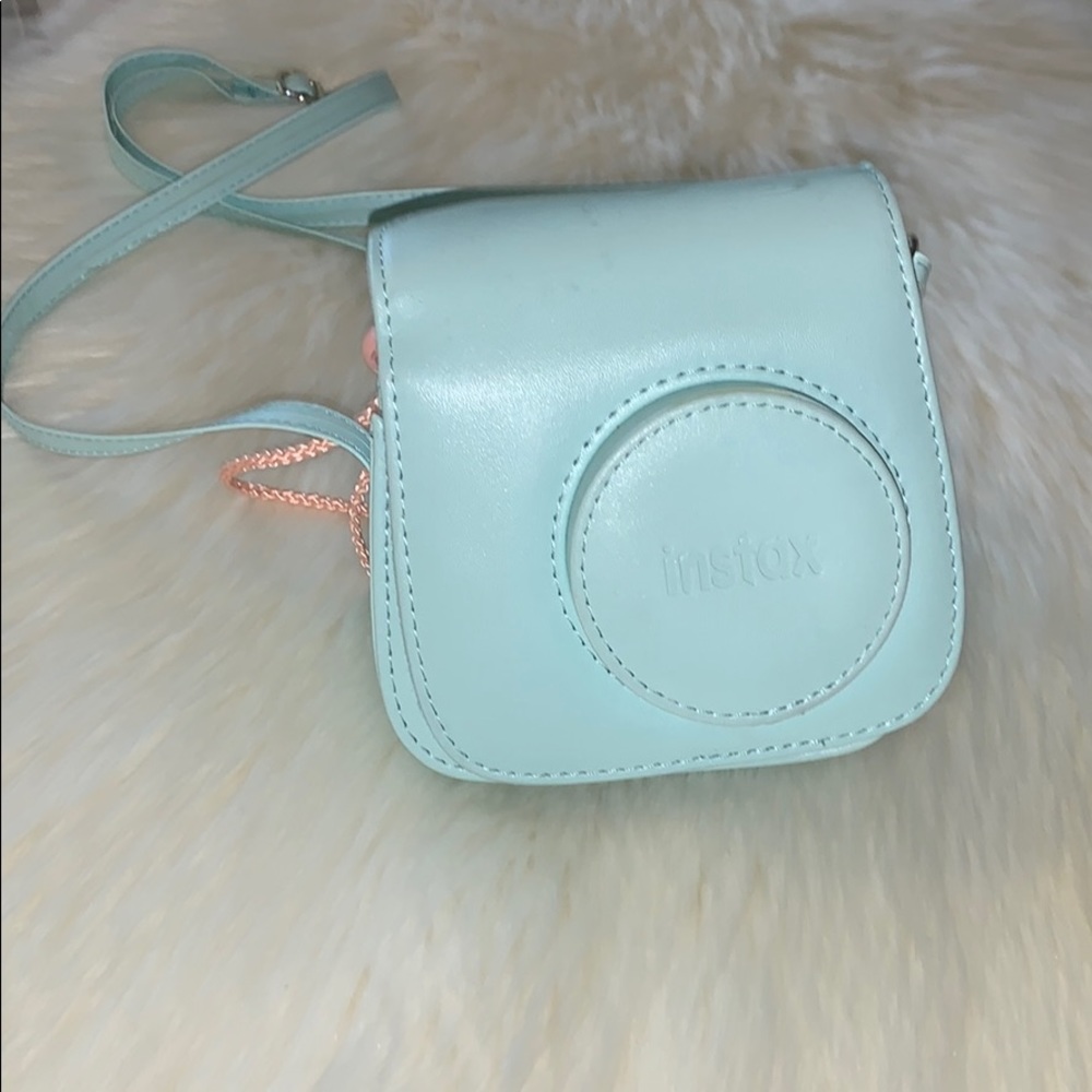 A  Instax camera with his blue suitcase 💙